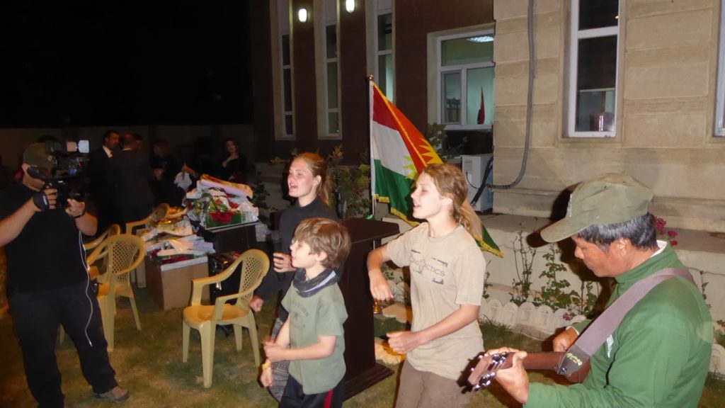 Sahale, Suuzanne and Peter sing "Peshmerga Lead the Way" at the program.