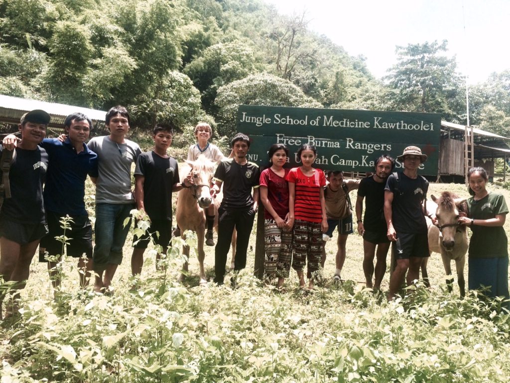 Some of JSMK medics and staff in front of clinic with Pete and Freedom, part of FBR cavalry 