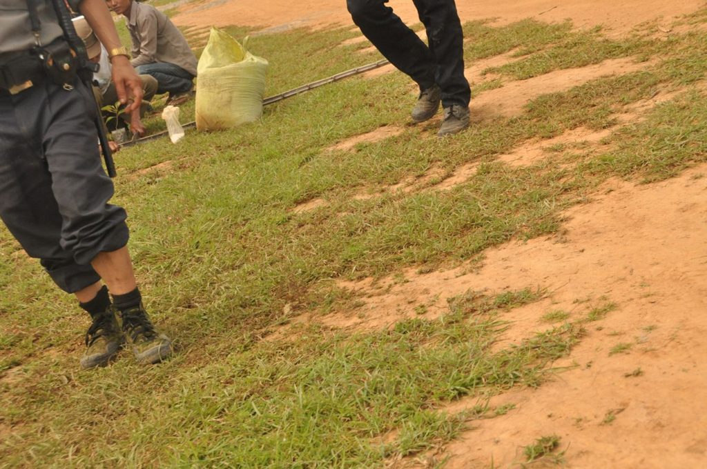 Armed police and soldiers guard the deconstruction efforts at Bualpui village, Falam Township, Chin state. 