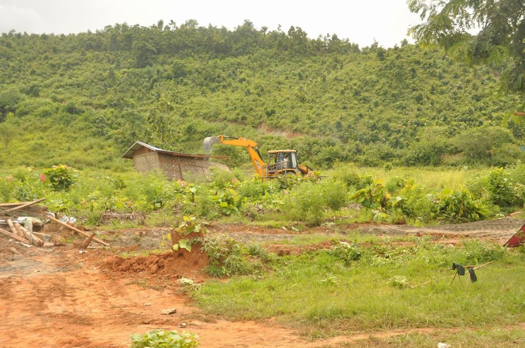 Burmese government operated backhoe loader removing structures in Bualpui village on August 31st, 2016. Falam Township, Chin state.