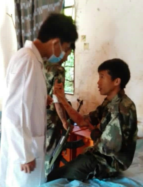 A KIA soldier receives medical attention after being wounded in a clash.