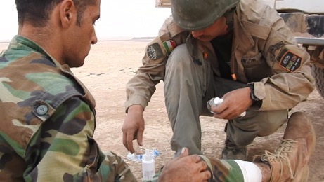 Team treating wounded Kurd Peshmerga outside Omar Qamshi Photo; FBR