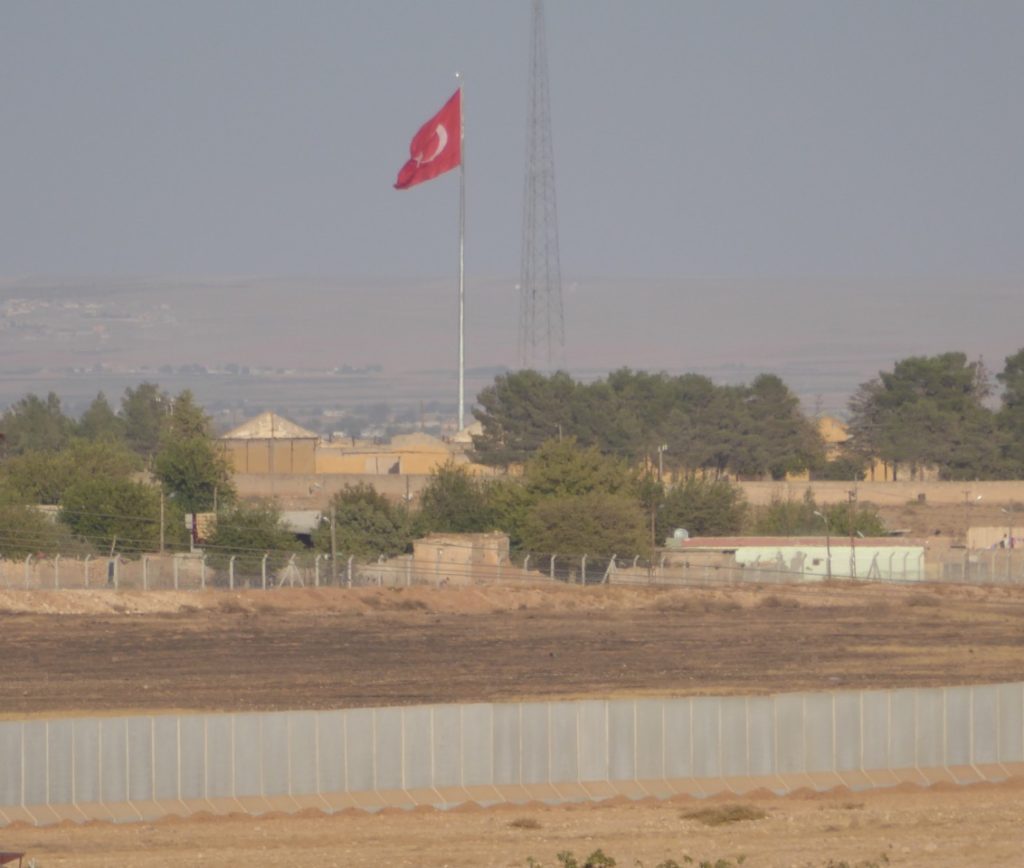 Turkish flag and new border wall outside Kobane, Syria