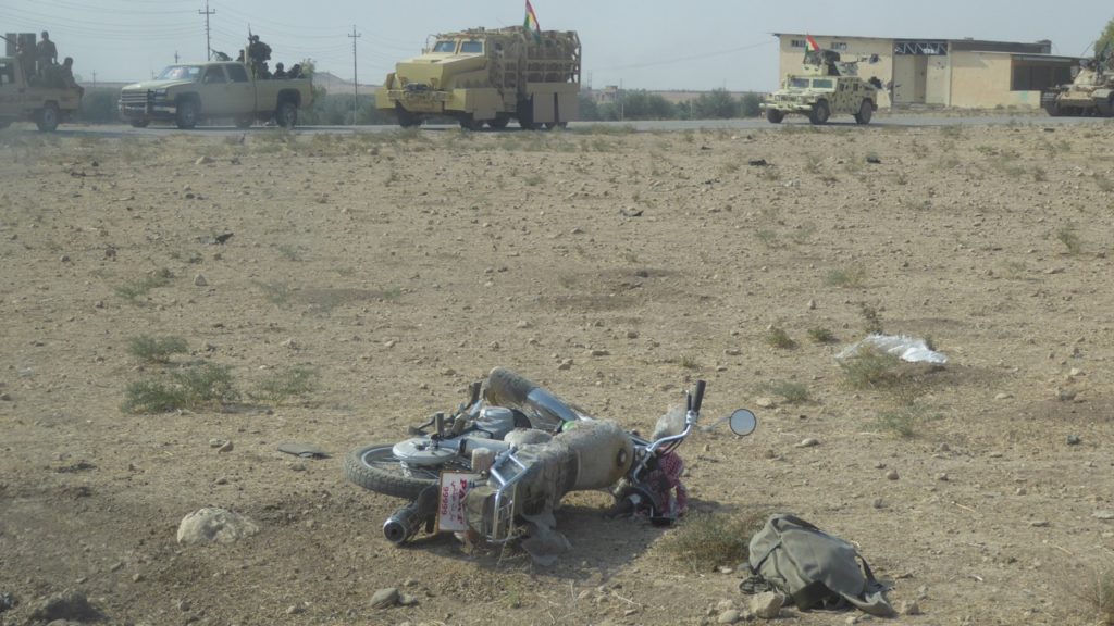 ISIS gunner abandones his motorcycle as Kurds advance.