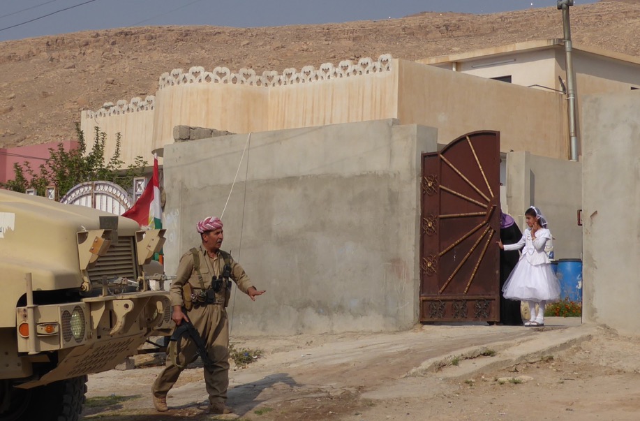 Girl watches as Kurd column enters Faizalia.