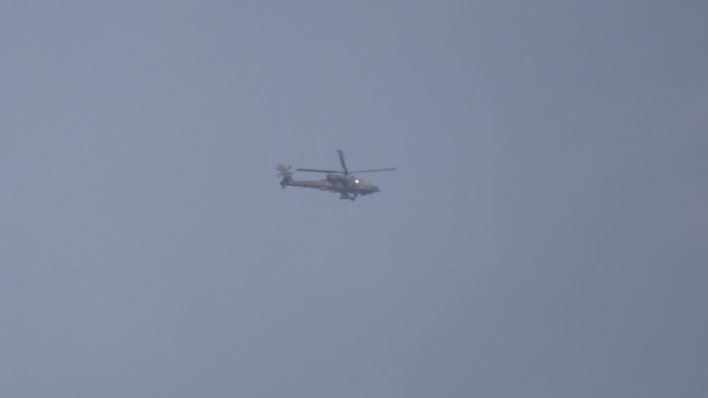 Coalition attack helicopter flies in support of the liberation.