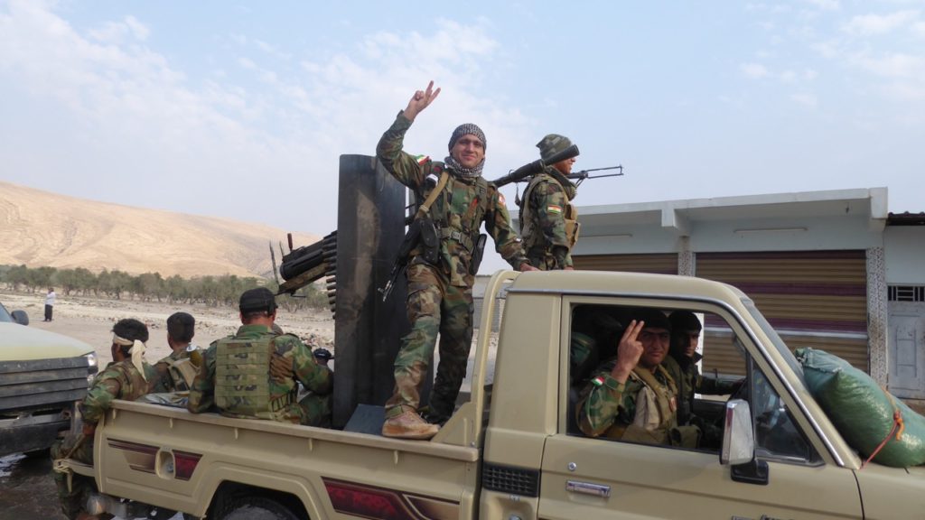 Kurdish soldiers celebrate the liberation of Faizalia.