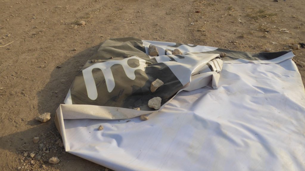 ISIS flag on the ground.