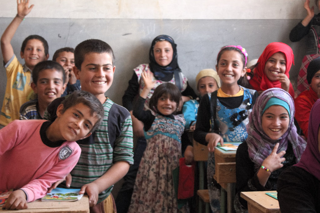 Children smile in a newly reopened school in Mambij. Photo: FBR.