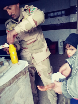 Iraqi army taking care of a little boy who was hit with shrapnel. 