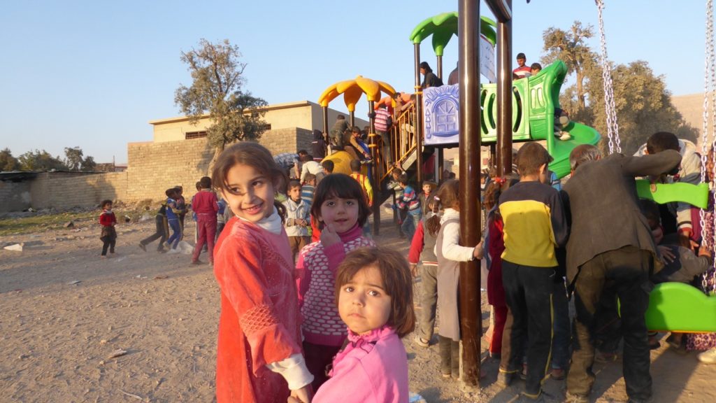 Girls play on the new playstructures. Photo: FBR.