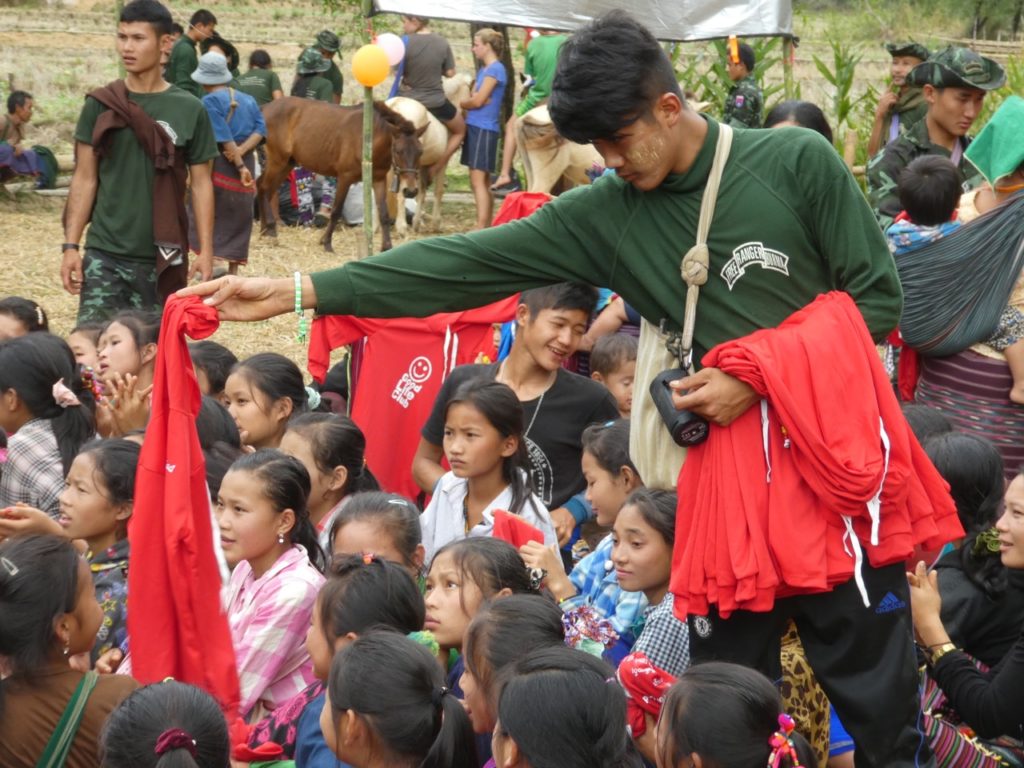 New teams give out GLC shirts to Karen children.