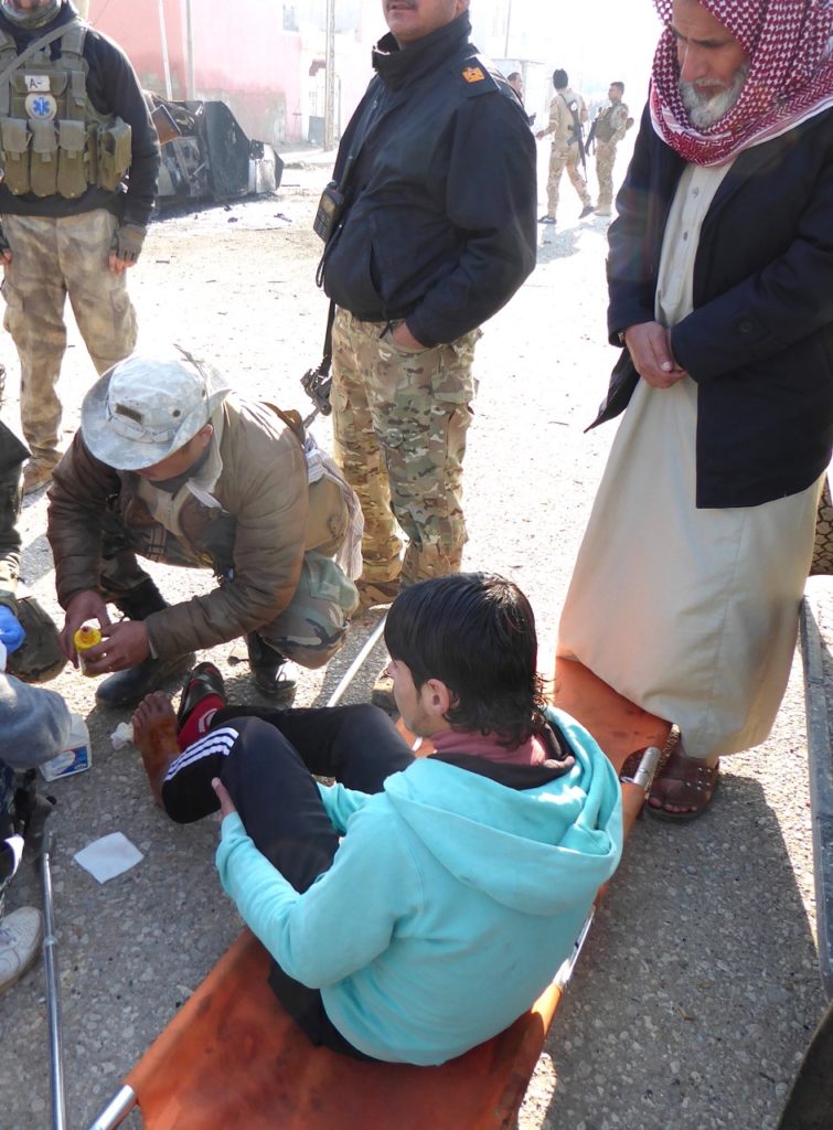 Eliya treats civilian wounded by ISIS mortar.