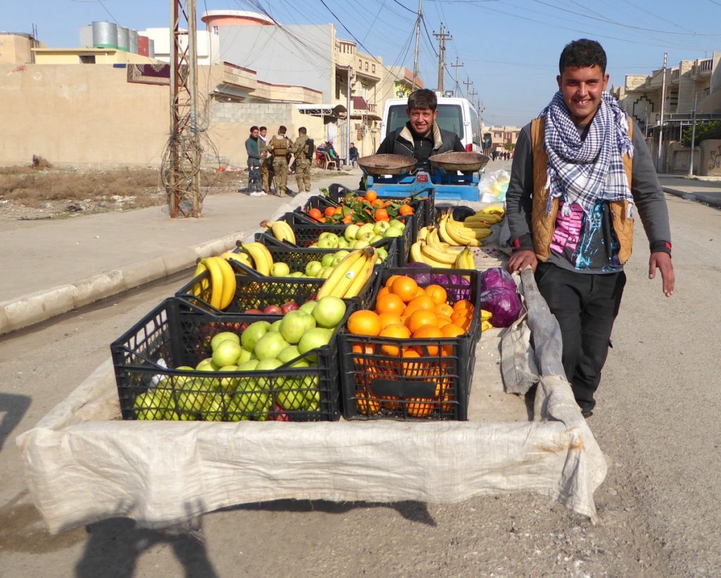 Happy fruit vendor in liberated eastern Mosul.