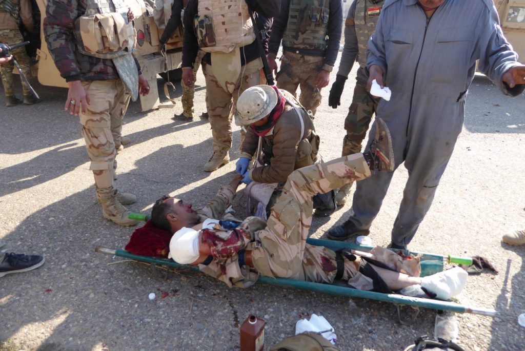 Eliya treats Iraqi solder wounded by ISIS trip wire explosion near Tell Kyf, north of Mosul 