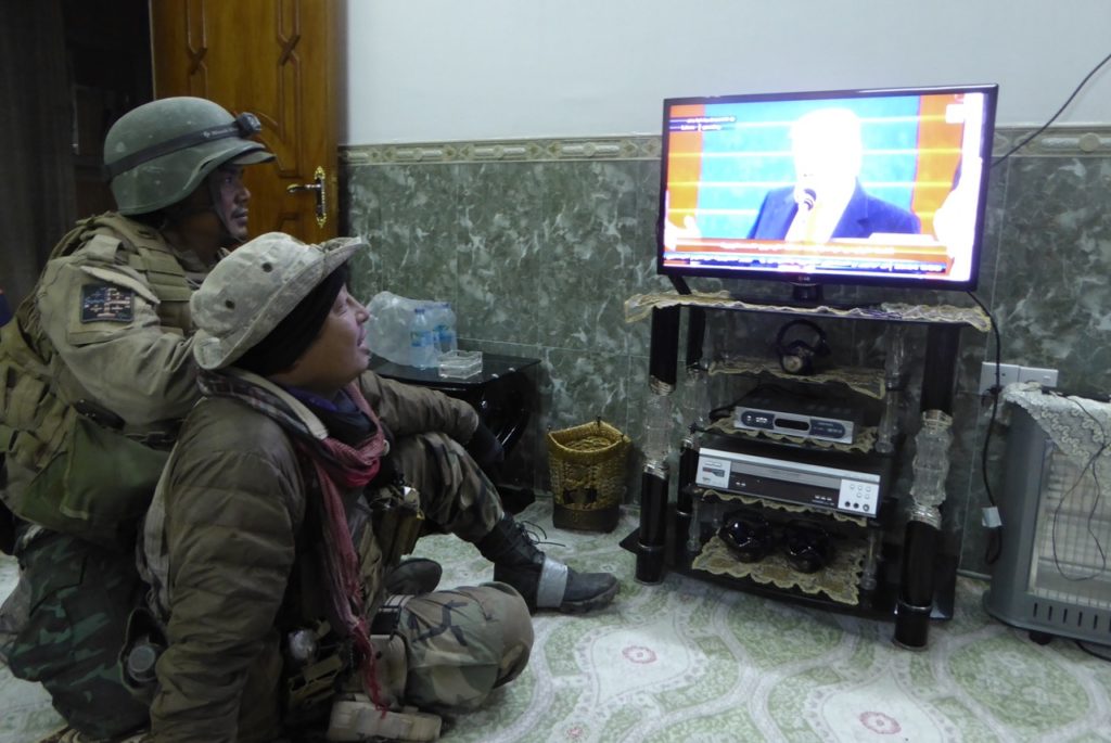 Eliya (right) and Zau Seng watching Trump Inauguration in a newly liberated neighborhood of NE Mosul 