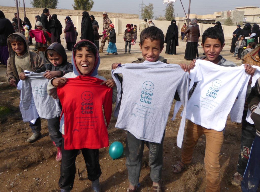 Mosul children get Good Life Club shirts after a kids program