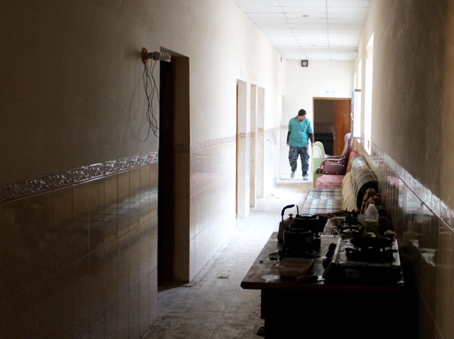 An Iraqi Federal Police E.R.D. Medic walks down the hall of the school-turned-emergency care center.