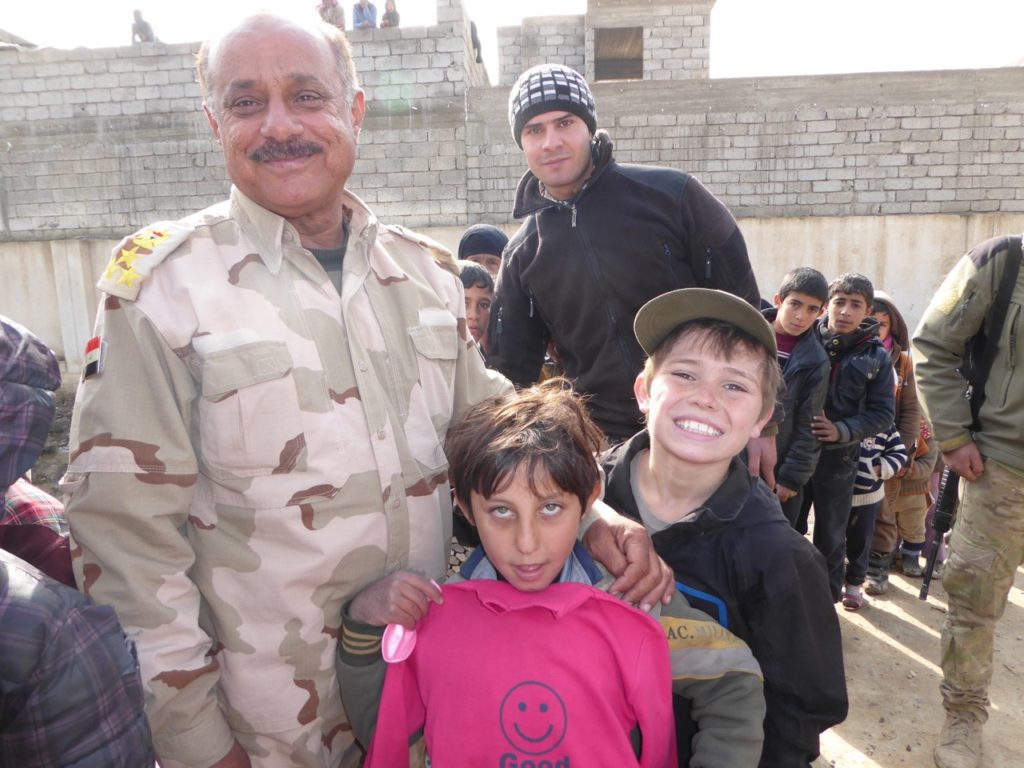 General Mustafa, commander of the 36th Iraqi Armored Brigade, after the battle of Salam hospital with Iraqi child and our son Peter at childrens program in Mosul