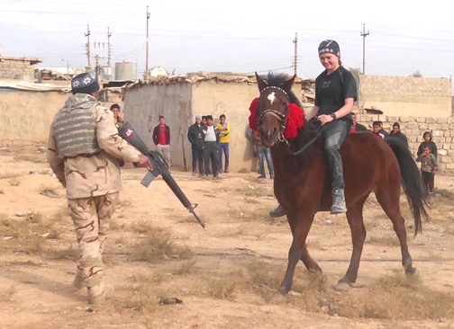 Sahale on a horse that survived ISIS in Mosul. Iraqi soldier gets out of the way!
