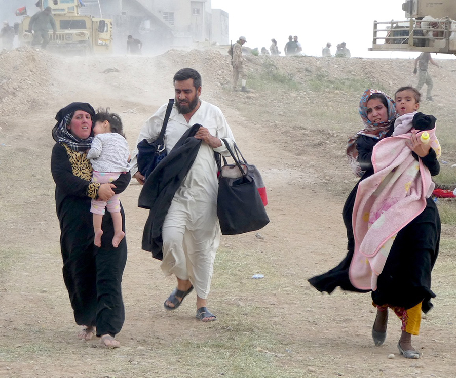 Families under ISIS fire flee Mosul.