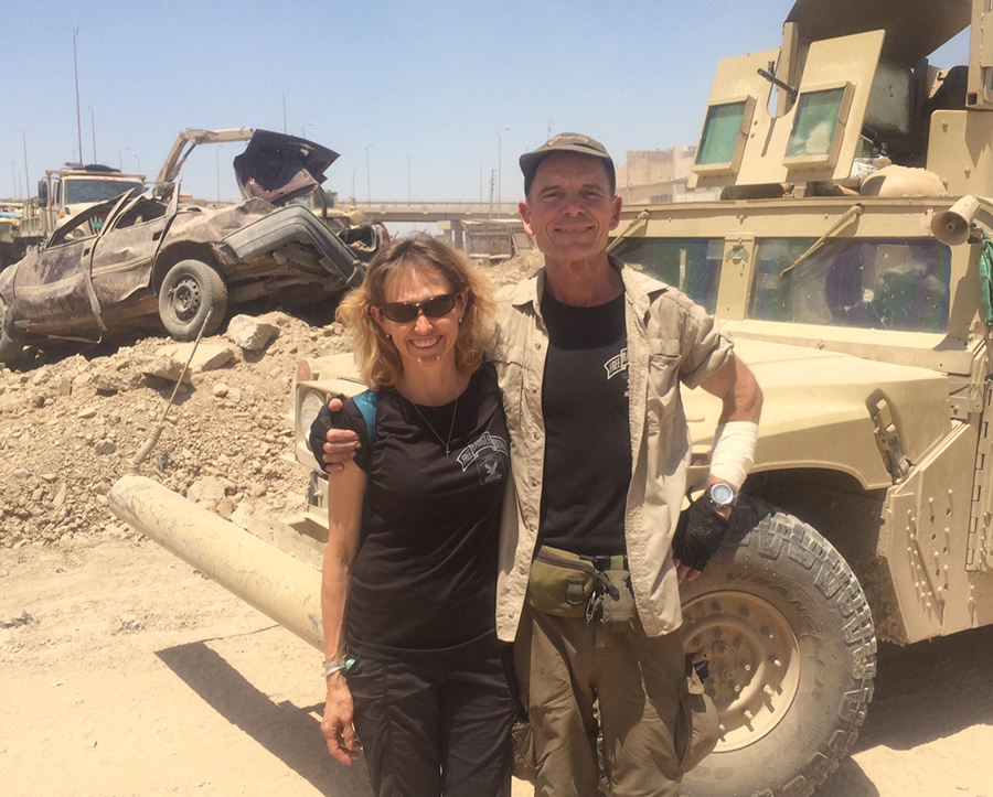 Karen and I and our Humvee the Iraqi Army so graciously let's us use. It has been hit over 20 times and was hit by a mortar after this photo but it keeps moving!