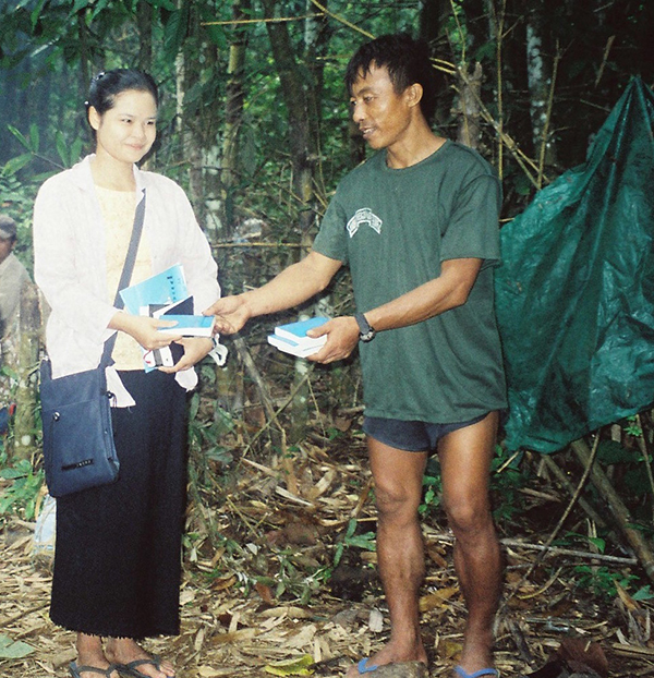 Mucu hands out bibles during a relief mission in Karen State, Burma, 1998.
