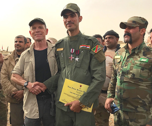 Presenting valor and wounded medals to a Iraqi hero friend.