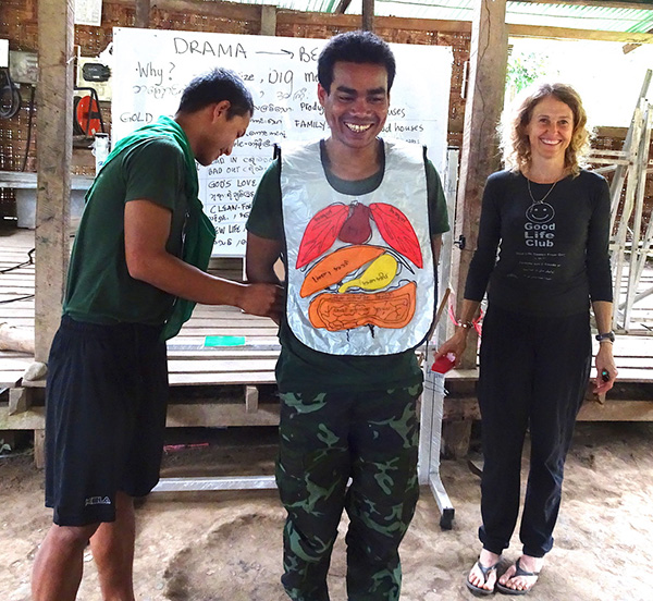 Karen helps teach the GLC anatomy apron to a new Arakan team. 