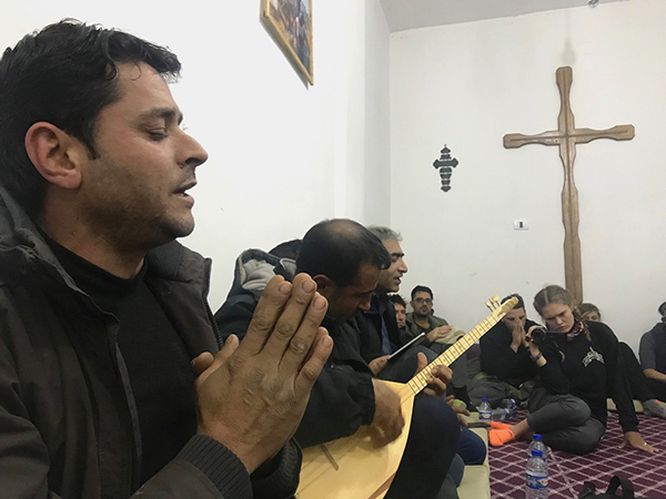 New Syrian Christians sing a prayer with traditional Kurdish guitar.