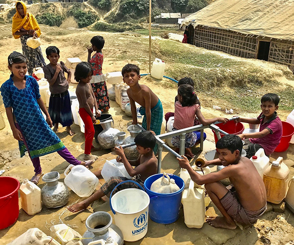 Rohingya refugees getting water from a pump in one of the camps.