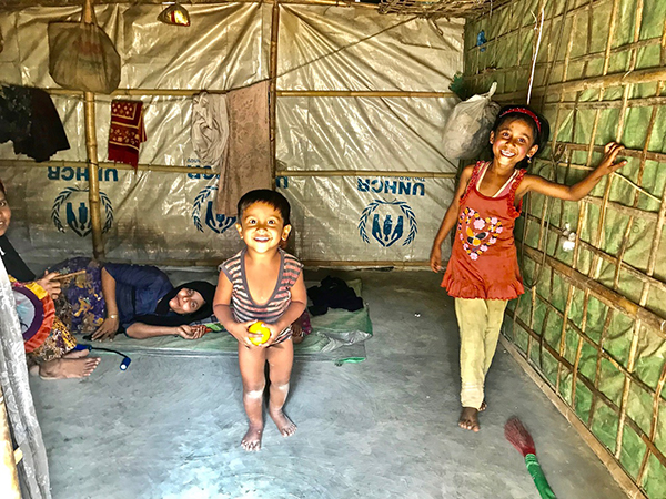 Surprised by smiles in a Rohingya refugee hut.