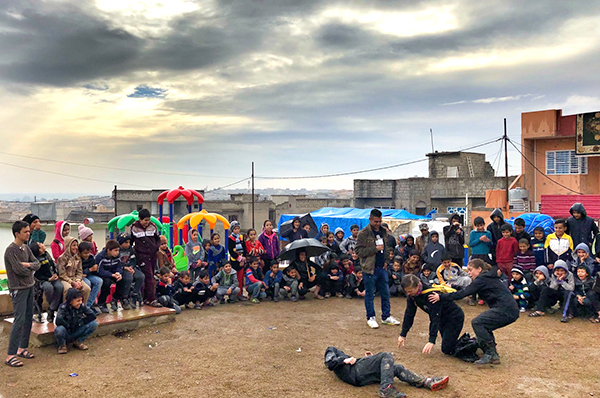 The team performs a Good Samaritan play for families at new play ground in Mosul, February 2018.