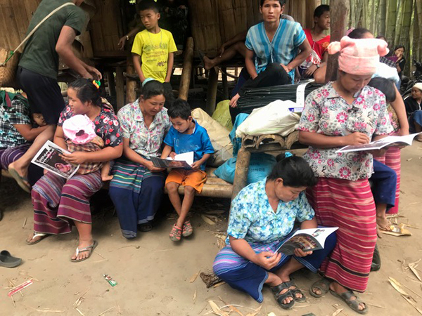 Karen IDPs reading the Global Day of Prayer for Burma magazine.