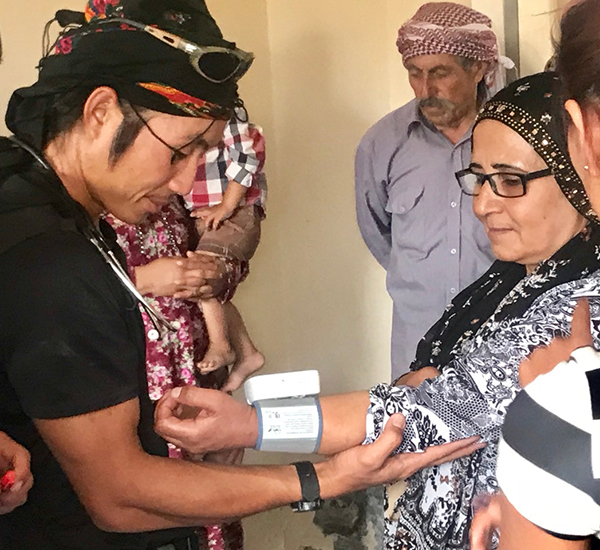 A Burma medic, Joseph, treats Yezidi IDPs from Afrin.