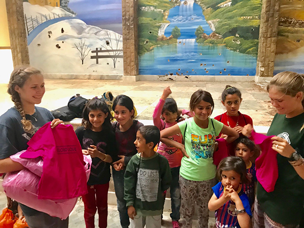 Suu and Sahale give out Reload Love t-shirts to Yezidi kids. 