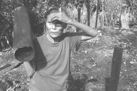 woman surveys burned home