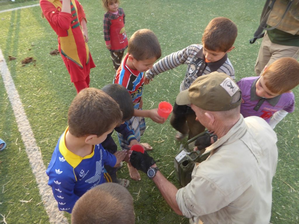 Our team giving water to the families who escaped