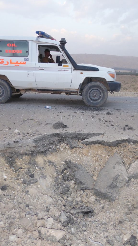 Our ambulance driving by one of the IEDs that exploded 30-yards from our armored vehicle earlier on the approach into Faizalia.