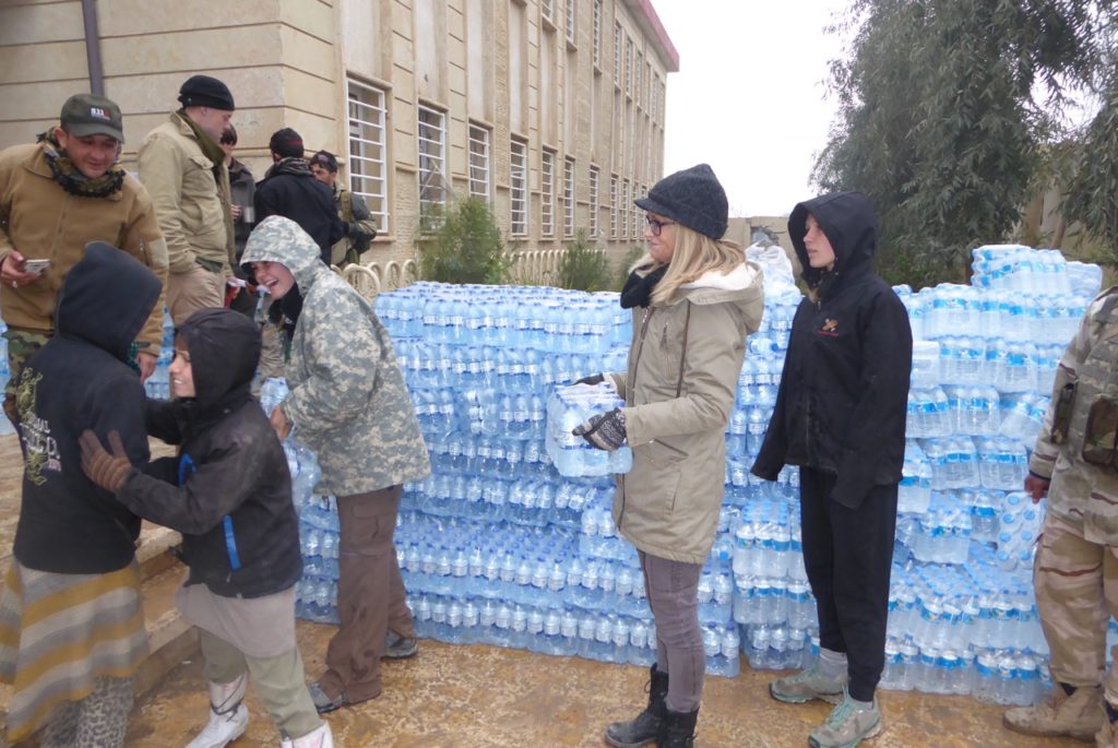 Joyce of Partners helping our kids give out water and love in NE Mosul