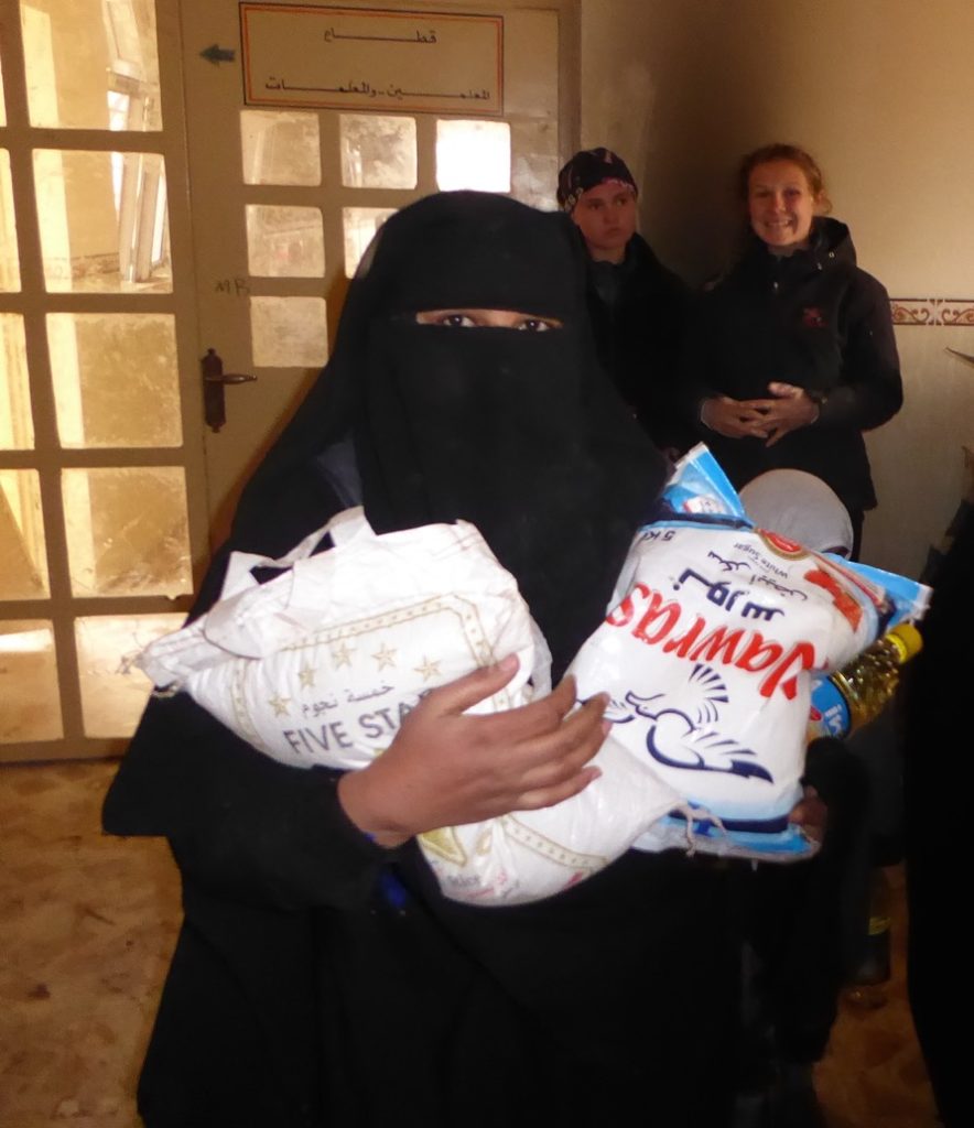 Woman with family food staples