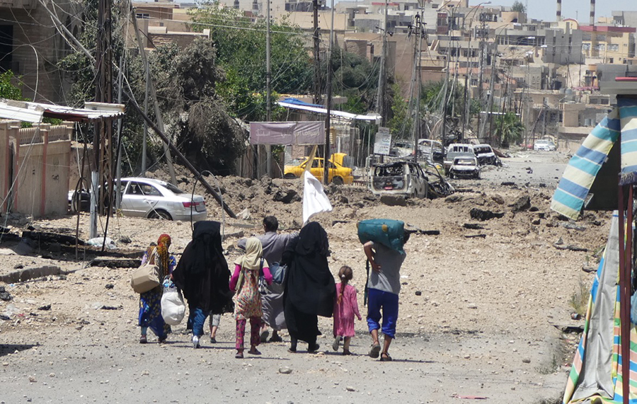 Families with white flags escape ISIS.