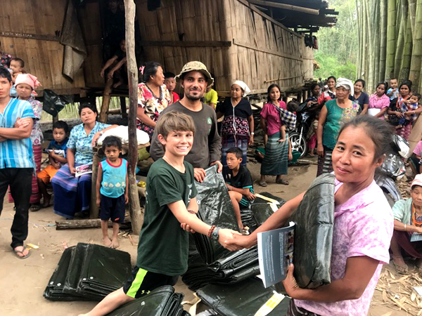 Mohammed, our Iraqi FBR team member, and Pete hand out tarps.