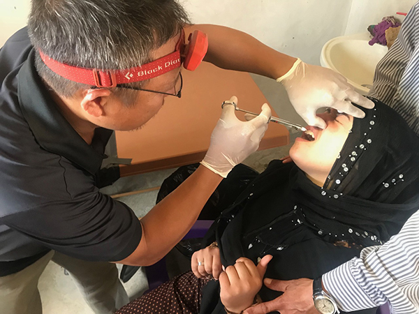 Eliya, a Karen medic, does dentistry for IDPs near Menbij