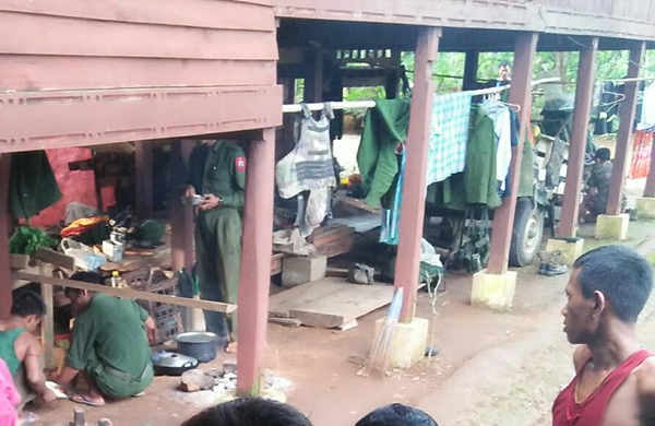 Burma Army soldiers using a civilian home in Ta La All Kho Village.