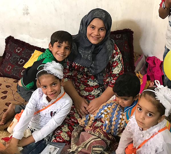 Eman with Suriya (front left) and some of her siblings. Eman needs surgery to walk again.