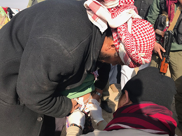 A Karen FBR medic, Eliya, treats the wounded girl.