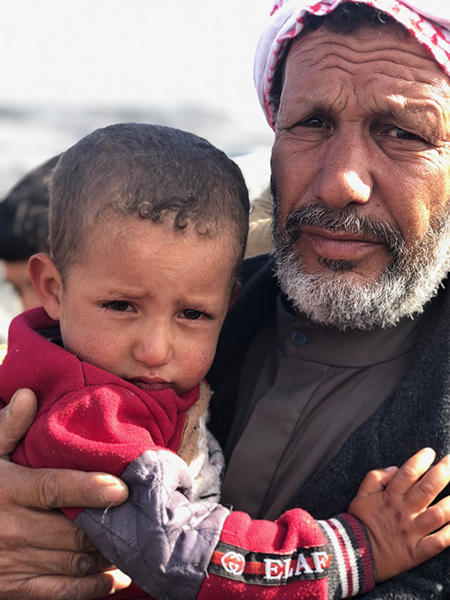 A man with his grandson whose father was killed.