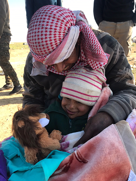 A child receives a stuffed lion toy.