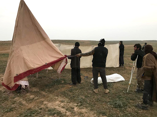 Helping set-up tents for the new arrivals.